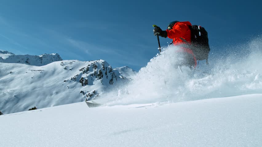 Freeride skier riding in the scenic mountains. Super slow motion at 1000 fps.