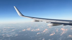 Airplane flight. Wing of airplane flying above clouds with sunset sky. Illuminator view on plane wing. Traveling by air on Airplane or Aircraft. 4K video shot on smartphone. Airplane Window View USA - Powered by Shutterstock - Get 15% off with code: PIKWIZARD15