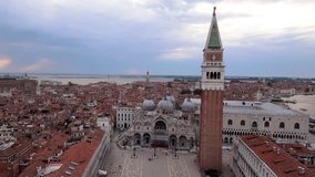 Zoom out aerial view of St. Mark's square, Venetian Lagoon, Venice canals. sunset time, Italy, 4k video