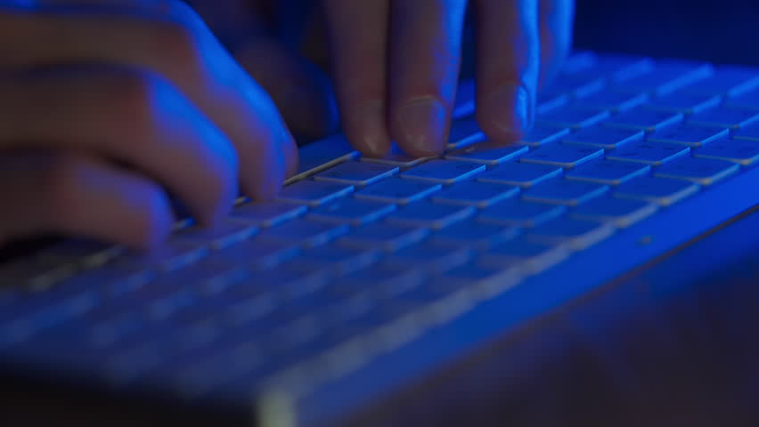Hands typing on keyboard. Blue light. Man working on computer in dark. Close up fingers typing on computer. Working night. Work force. Late night working in office. Male office worker tapping fingers | Shutterstock HD Video #1100121033