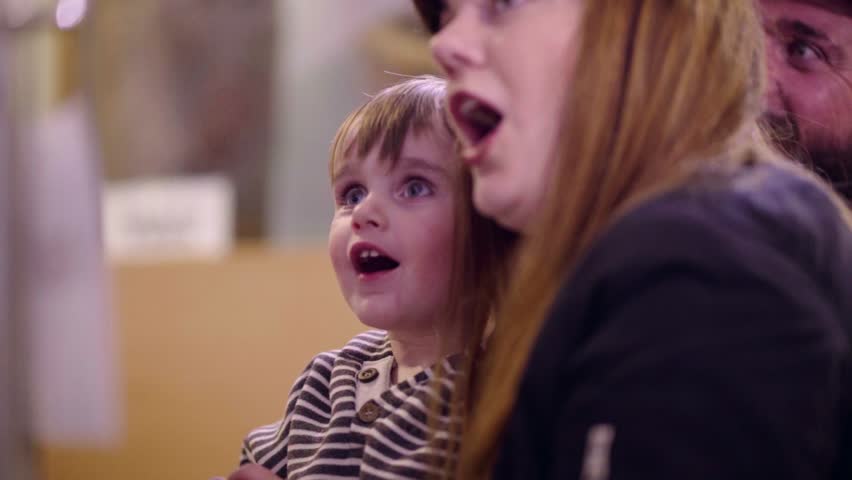 excited and surprised child with his mother