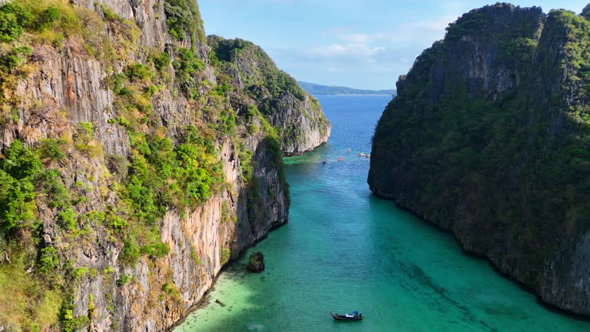 Tropical vacation in Thailand, aerial view of Pileh lagoon and Koh Phi Phi island on Thai resort, idyllic exotic landscape with traditional Thai boat in Maya bay. High quality 4k footage | Shutterstock HD Video #1100125925