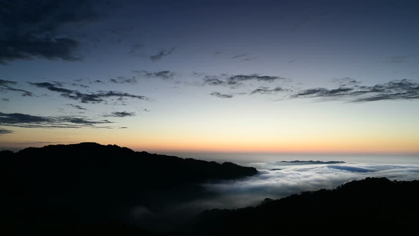 Layers of surging clouds are very spectacular. Sunset behind the mountains. The sea of clouds landscape. Dahu Township, Miaoli County, Taiwan