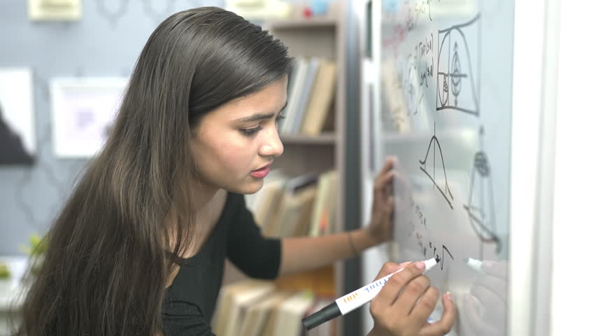 Indian teen student worried write formula think of sums on white board with marker pen at educational institute. Schoolgirl face problem while solving mathematics addition questions in classroom Royalty-Free Stock Footage #1100132875