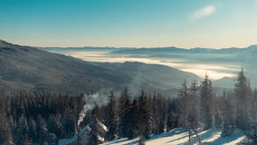 Winter Landscape in Mountains. Fog Flows Through The Valley, Smoke Comes From the Chimney of a Log Cabin, Melting Snow Falls From the Fir Trees and Crows Sit on the Trees. Time Lapse Video - Powered by Shutterstock - Get 15% off with code: PIKWIZARD15