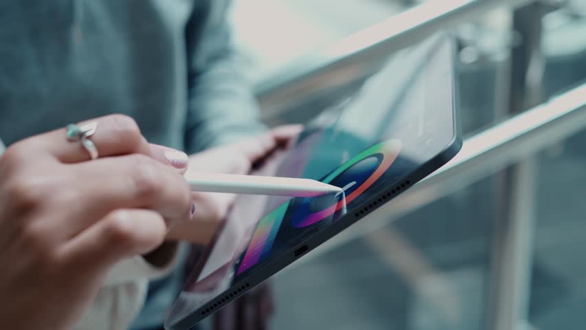 Close-up. female designer sketching on a digital tablet. | Shutterstock HD Video #1100133869
