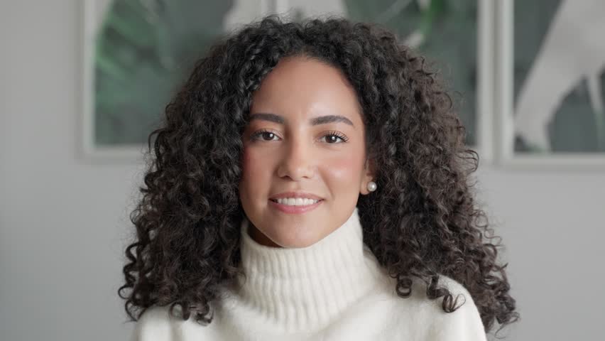 Young smiling pretty latin lady having fun feeling happy at home, beautiful positive cute hispanic woman with perfect white teeth and dental smile posing indoors advertising dating website, portrait. Royalty-Free Stock Footage #1100134591