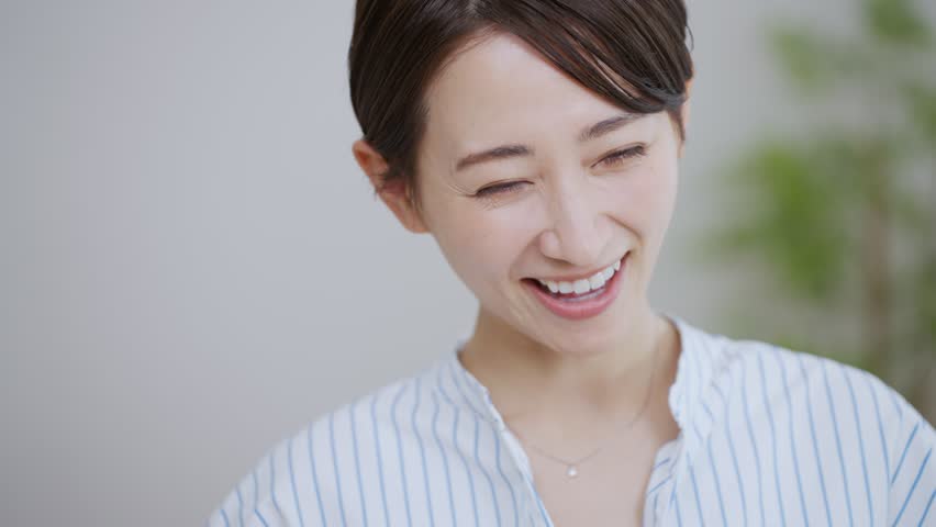 Smiling middle-aged Asian woman in the room | Shutterstock HD Video #1100135175
