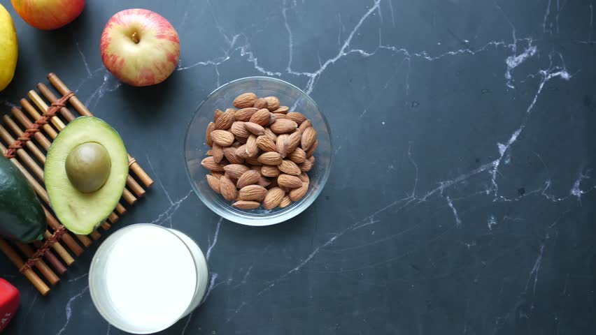 Fruits and almonds and yogurt  measuring tape avocado | Shutterstock HD Video #1100135723