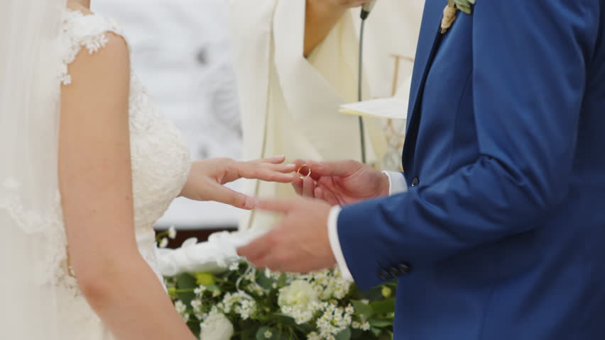 Bride and groom wear their wedding ring | Shutterstock HD Video #1100136949