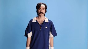 Man with moustache, trainer, coach in sport uniform with timer over blue background. Cheering up. Retro style. Concept of sport, fitness, competition, occupation, profession, training activity