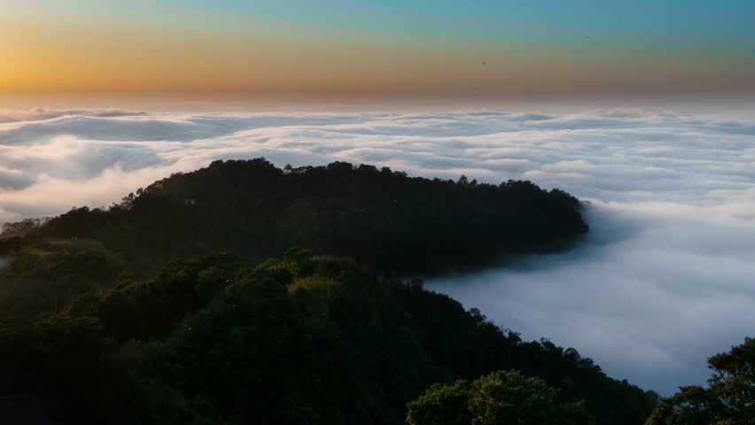 Layers of surging clouds are very spectacular. Sunset behind the mountains. The sea of clouds landscape. Dahu Township, Miaoli County, Taiwan