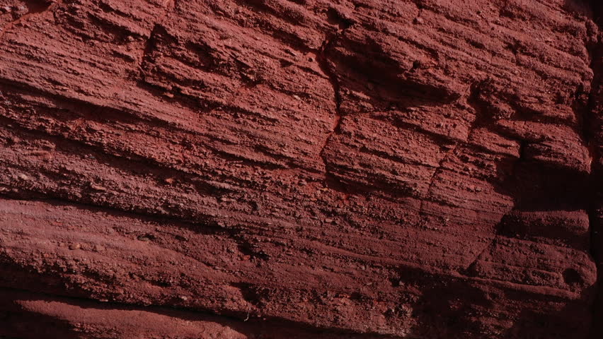 Abstract background of sandstone cliff on the coast aerial view as drone moves up the face of the rock south coast of England UK 4K