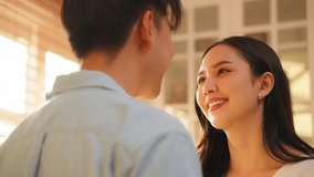 Asian young man and woman kissing each other in living room at home. Attractive romantic new marriage couple male and female spend time celebrate anniversary and valentine's day together in house. - Powered by Shutterstock - Get 15% off with code: PIKWIZARD15