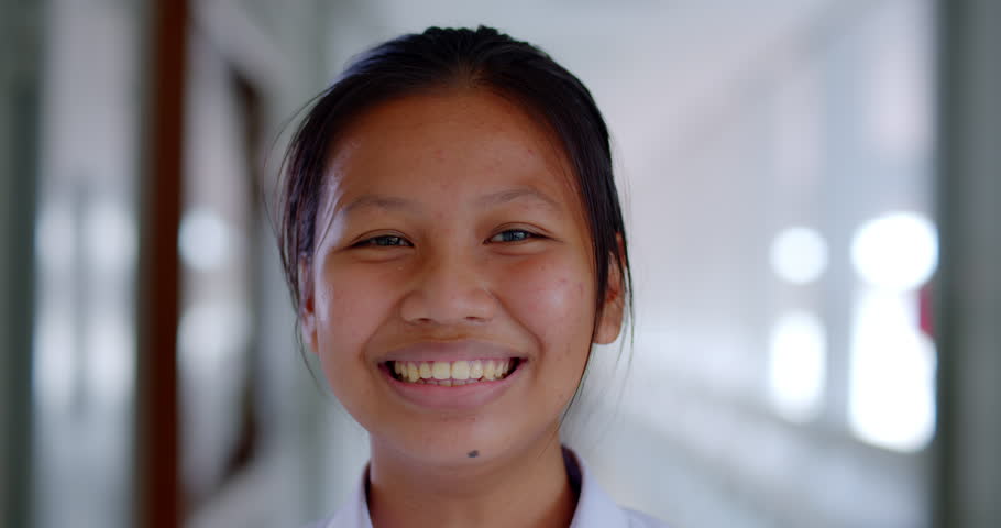 Slow motion scene of a happy smiling and laughing Asian high school student girl who is native and has acne on his face. | Shutterstock HD Video #1100144091