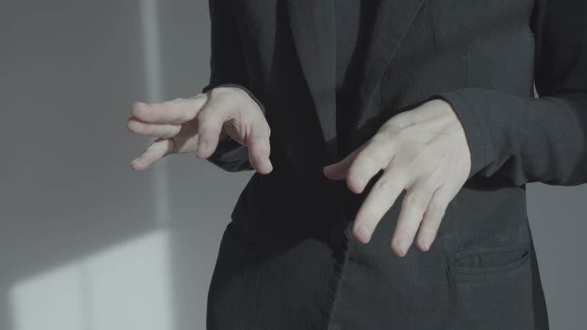 A woman in a business suit is nervous and actively gesticulating. In the frame close-up of the hands at the level of the abdomen. Emotional self-expression. | Shutterstock HD Video #1100146127