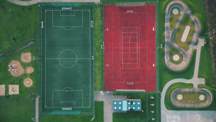Recreational green grass active sports hockey and football fields overhead top down view. Competition court active outdoor people and children on the field. The Netherlands