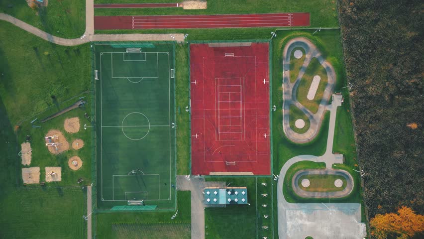 Recreational green grass active sports hockey and football fields overhead top down view. Competition court active outdoor people and children on the field. The Netherlands
