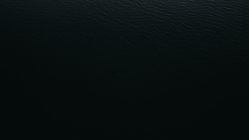 Slow drone tilt up over Dundalk Bay while the sun sets. Dundalk, Ireland.