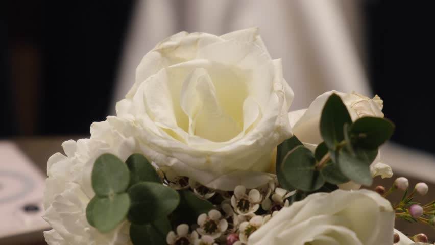 White rose flower bridal bouquet, wedding dress in background, bride waiting | Shutterstock HD Video #1100152637
