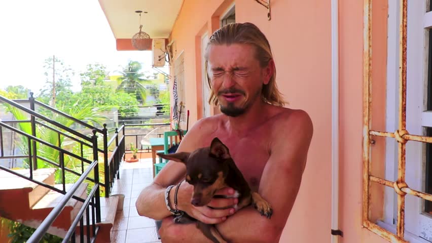 Sad crying man with dog in Playa del Carmen Quintana Roo Mexico.