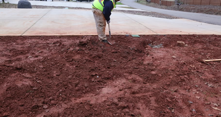 Drainage pipe for rain water is laid in lot of parking lot, which covered with gravel, driveway is sealed
