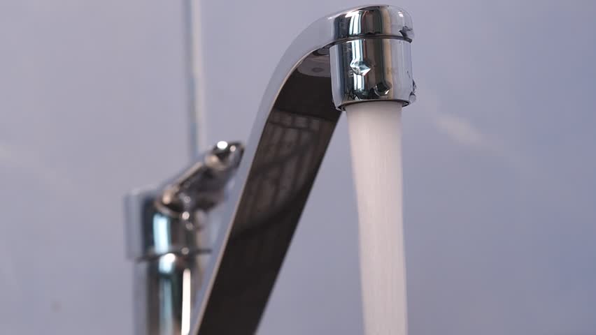 Water is pouring from the kitchen tap in the sink. | Shutterstock HD Video #1100158451