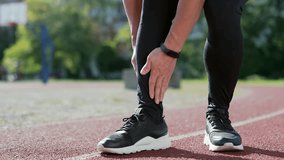 Close up; injured leg of a male athlete at the city stadium. Man massaging stretching, trauma injury while jogging outdoors. Fitness male sprain severe pain stretch pull. Leg muscle cramp calf sport - Powered by Shutterstock - Get 15% off with code: PIKWIZARD15