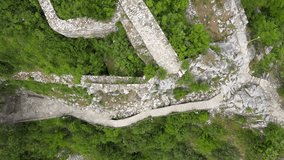 Aerial drone top down footage of a fortress castle in Bulgarian mountains. Old architectural video
