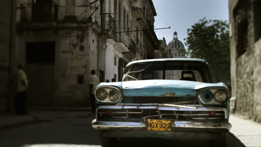 Timelapse of a classic car in havana with fast moving street scene 