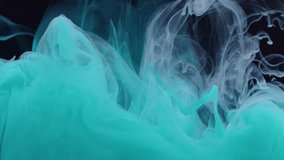 White and turquoise paint drops in water on a black background, abstract and beautiful wave of ink. 8K downscale, a vertical frame slow motion. Filmed on cinema camera, 4K. - Powered by Shutterstock - Get 15% off with code: PIKWIZARD15