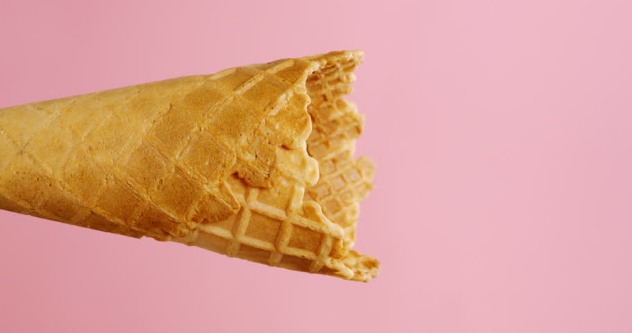 Vertical video, Vanilla ice cream scoop in cone on pink background, delicious ice cream concept. | Shutterstock HD Video #1100165995