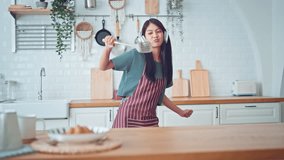 Slow motion of happy young asian woman dancing with headphones at home having fun relaxing with funny dance moves enjoying freedom on weekend morning. People, Lifestyle and joy concept. - Powered by Shutterstock - Get 15% off with code: PIKWIZARD15