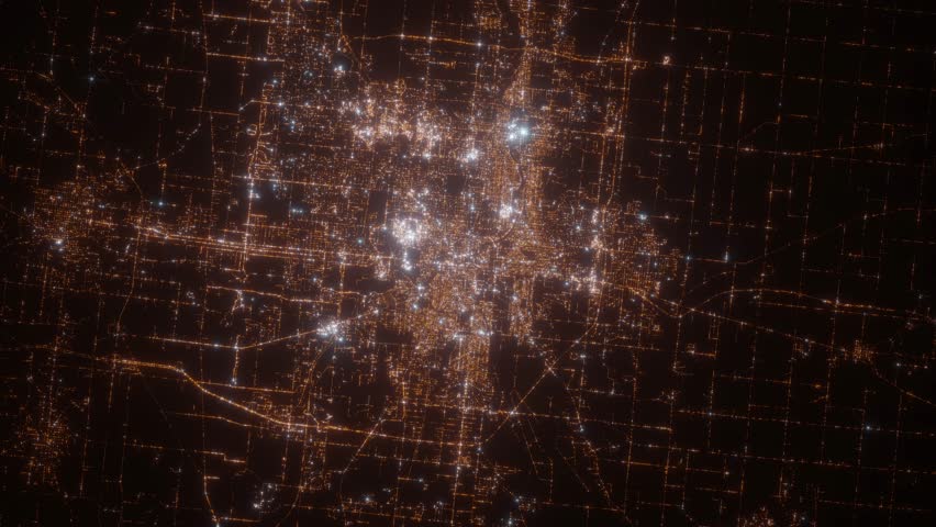 South Bend (Indiana, USA) aerial view at night. Top view on modern city with street lights. Camera is zooming out, rotating clockwise. Vertical video. The north is on the left side