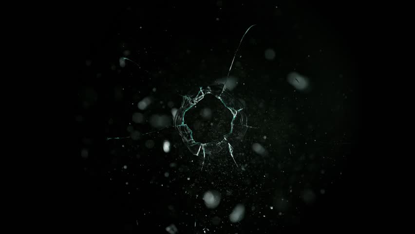 Super Slow Motion Shot of Real Bullet Hole Glass Break Isolated on Black Background at 1000fps.