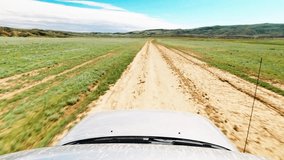 First person view front side 4WD vehicle drives real time on gravel road off-road in Chachuna nature reserve wilderness. 4k quality video exploration off-road tours outdoors in caucasus