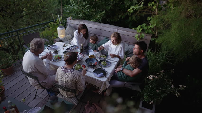 Friends and family eating food together at home patio backyard | Shutterstock HD Video #1100176297
