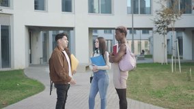 a group of college students at the university campus talking about exams.