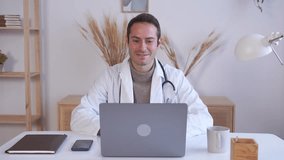 Cheerful doctor making video call