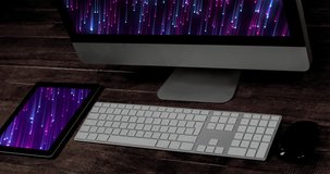 Animation of technological devices with light trails on screen on desk. Global technology, abstract background and digital interface concept digitally generated video.