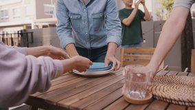 Group of man woman asia people fun joy prepare set dine table plate glass cutlery in cozy party host event at home front yard patio. Young adult child friend enjoy happy warm time picnic lunch meal. - Powered by Shutterstock - Get 15% off with code: PIKWIZARD15