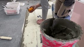 4k video footage of laying a large wide-format tile for mortar.