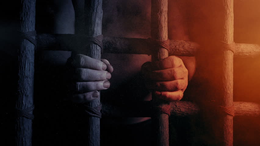 Prisoner Holds Bars In Dusty Sunlight | Shutterstock HD Video #1100192257
