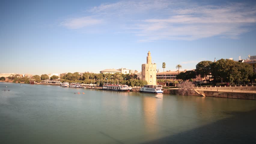 Time lapse of the Guadalquivir river and the Torre del Oro in Seville, Spain. Seville Skyline.