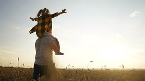 father and daughter in the park. happy family a behind his back walking in a wheat field silhouette. happy family kid dream concept. father and daughter piggyback happy family sunset - Powered by Shutterstock - Get 15% off with code: PIKWIZARD15