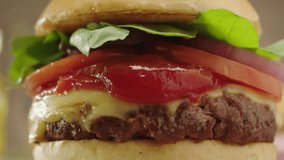 cheeseburger being smashed with dripping ketchup in slow motion and zoom in - Powered by Shutterstock - Get 15% off with code: PIKWIZARD15