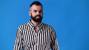 4k video of one man points to the right over blue background.