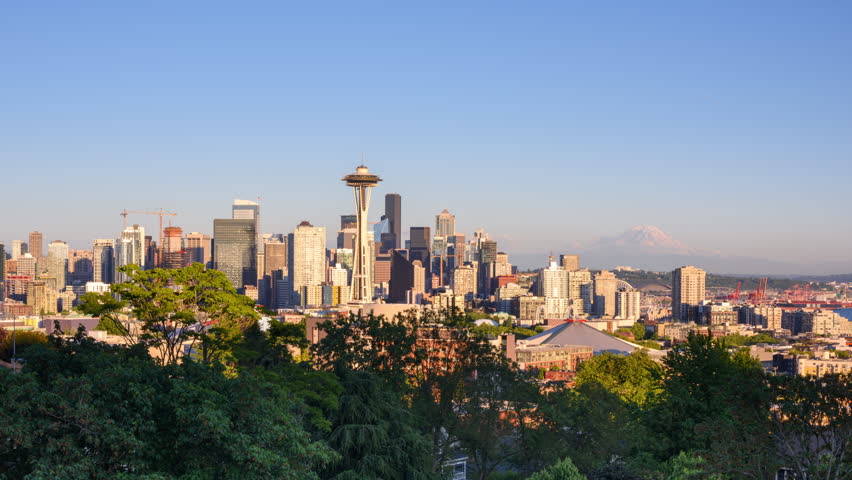 Seattle, Washington, USA downtown skyline from dusk till night with Mt. Rainier.
