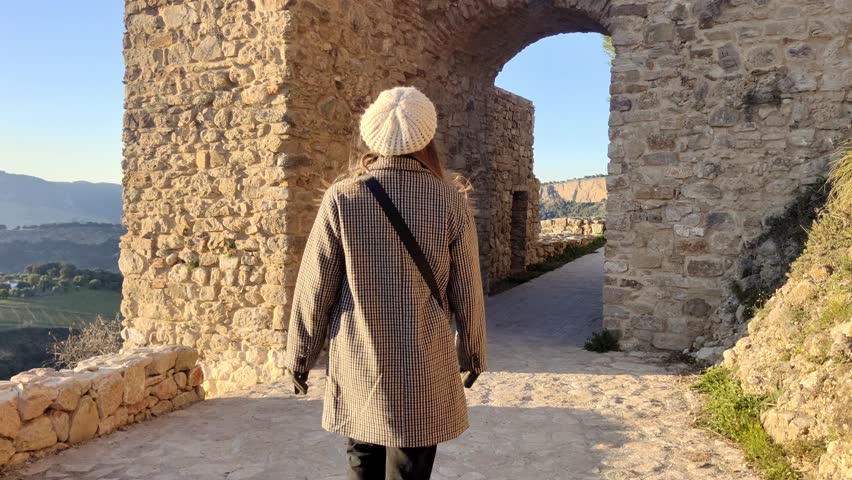 Tracking shot of a woman walking and exploring the sites at Ronda, Spain