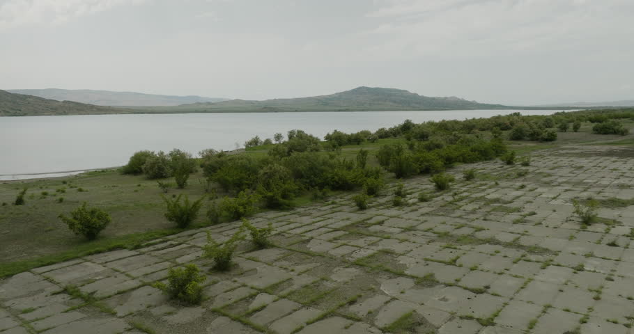 Concrete dyke wall with bridge on shore of Dali Mta reservoir, Georgia.